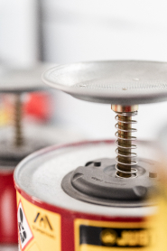 Close-up of gas canisters with a metal pressure release mechanism on top.